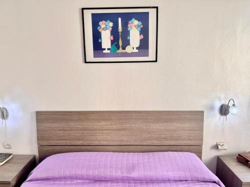 1 dormitorio con 1 cama con manta morada en Appartement Bab Lamrissa, en Sale
