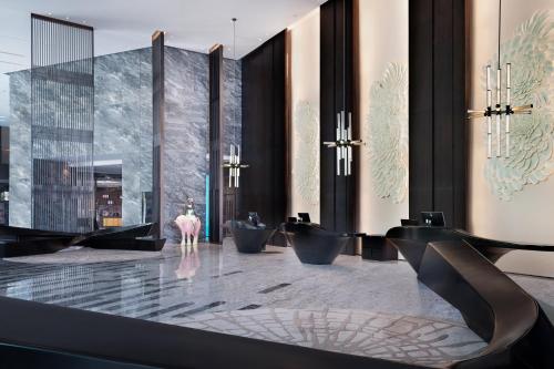 a bathroom with a row of sinks in a room at Le Meridien Zhongshan in Zhongshan