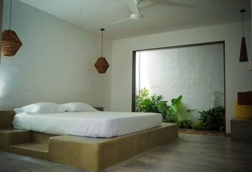 a bedroom with a bed and a large window at Casa Amarilla in Honda