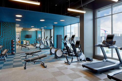 a gym with treadmills and ellipticals in a building at Aloft Chattanooga Hamilton Place in Chattanooga