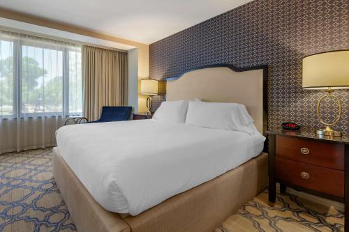 a hotel room with a large bed and a window at Best Western Premier Park Hotel in Madison