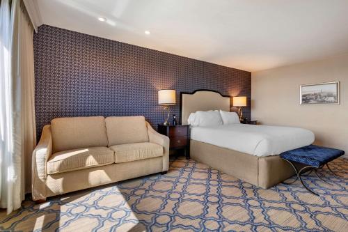 a hotel room with a bed and a couch at Best Western Premier Park Hotel in Madison