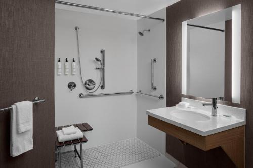 a bathroom with a sink and a shower at SpringHill Suites by Marriott Grand Rapids Airport Southeast in Cascade