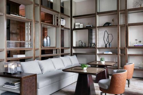 a living room with a couch and tables and shelves at JW Marriott Marquis Hotel Shanghai Pudong in Shanghai
