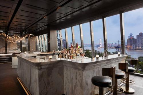 a bar in a building with a view of the city at JW Marriott Marquis Hotel Shanghai Pudong in Shanghai