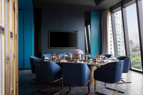 a dining room with a table and blue chairs at JW Marriott Marquis Hotel Shanghai Pudong in Shanghai