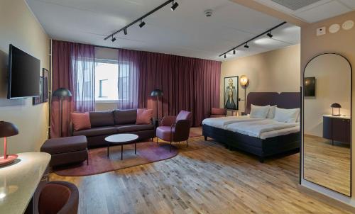 a hotel room with a bed and a couch at Scandic Kiruna in Kiruna