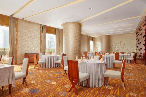 a dining room with tables and chairs in a room at The Westin Nanjing Xuanwu Lake in Nanjing