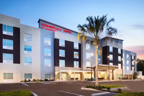 a hotel with a palm tree in front of a building at TownePlace Suites by Marriott Plant City in Plant City