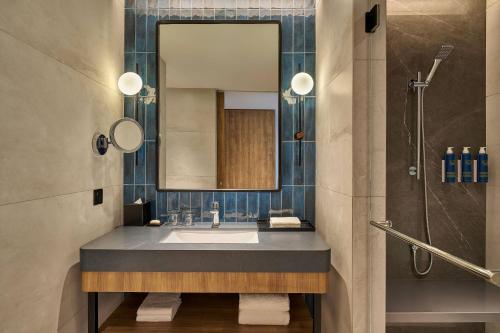 a bathroom with a sink and a shower at Four Points by Sheraton Kuala Lumpur, City Centre in Kuala Lumpur