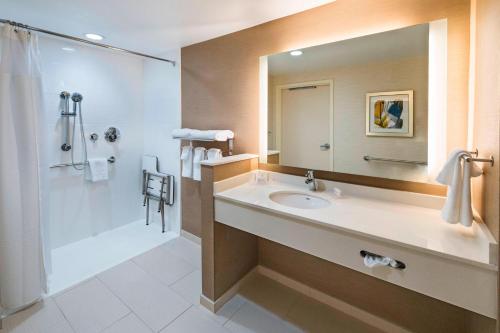 a bathroom with a sink and a shower and a mirror at Fairfield Inn & Suites by Marriott Dallas Waxahachie in Waxahachie