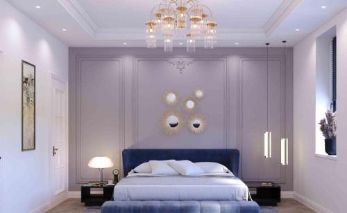 a bedroom with a blue bed and a chandelier at lema Hotel in Istanbul