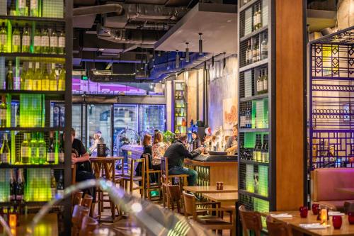 a restaurant with people sitting at a bar at DoubleTree by Hilton Melbourne in Melbourne