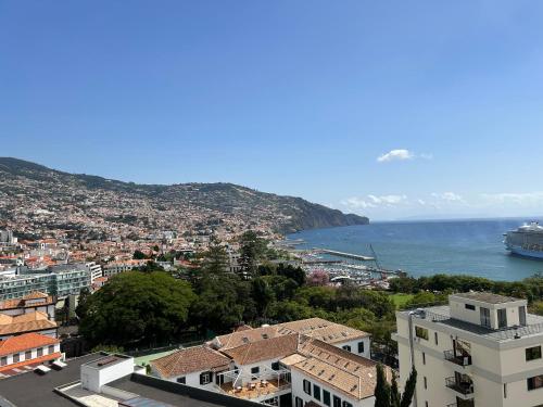 a view of a city and the ocean with a cruise ship at In Town View in Funchal