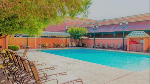 a swimming pool with chairs and a building at Boulder Station Hotel & Casino in Las Vegas
