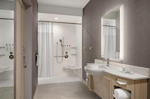 a bathroom with a sink and a shower at SpringHill Suites by Marriott Kalamazoo Portage in Portage