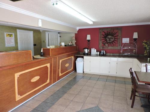 a kitchen with red walls and a table and a counter at Budget Inn Temple in Temple