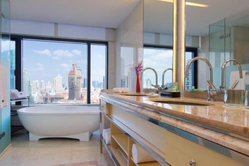 a bathroom with a tub and a large window at The Westin Bund Center, Shanghai in Shanghai