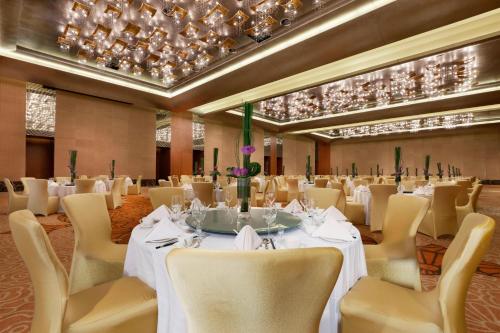 a banquet hall with white tables and chairs at Sheraton Grand Beijing Dongcheng Hotel in Beijing