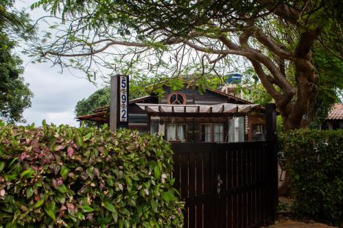 a house with a black fence and a hedge at Pousada Vila Nakau in Fernando de Noronha