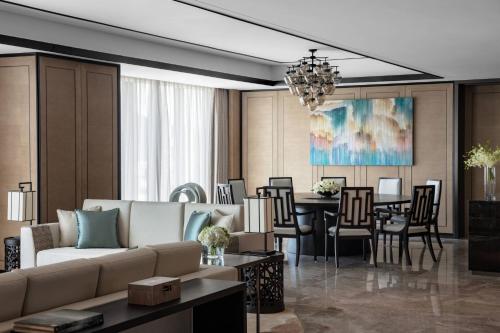 a living room with a couch and a dining room at Hangzhou Marriott Hotel Lin'an in Lin'an