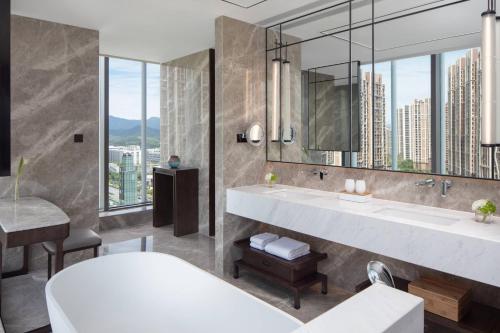 a bathroom with a large sink and a large mirror at Hangzhou Marriott Hotel Lin'an in Lin'an