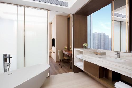 a bathroom with a tub and a large window at Courtyard By Marriott Xi'an North in Xi'an