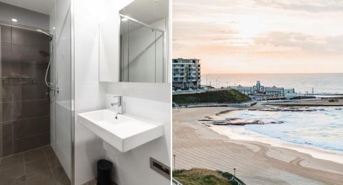 a bathroom with a sink and a view of the beach at The Echo - Arena Newcastle Beach in Newcastle