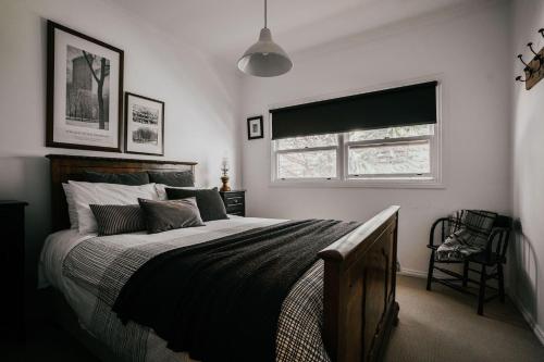 a bedroom with a large bed and a window at York House Daylesford in Daylesford