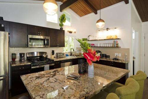 a kitchen with a marble counter top and a kitchen island at Romantic Retreat, Pop up Dome at your own private yard, Outdoor shower, firepit, 5 min to Hawaii Volcano park in Volcano