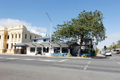 a building with a tent on the side of a street at Coffee House Apartment Motel in Rockhampton