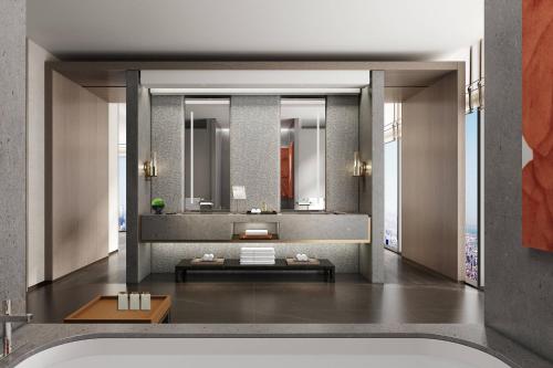 a bathroom with a tub and a large mirror at Courtyard by Marriott Luoyang in Luoyang