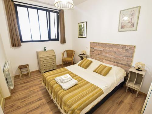 a bedroom with a bed and a tv in it at Gîte Sablé-sur-Sarthe, 3 pièces, 6 personnes - FR-1-410-380 in Sablé-sur-Sarthe