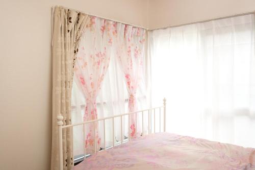 a bedroom with a bed and a window at Housegreen201 in Tokyo