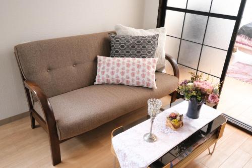 a living room with a couch and a table at Housegreen201 in Tokyo
