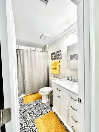 a white bathroom with a toilet and a shower at *The Gem* Stylish 2 Bedroom 1 Bathroom Newly Renovated in Ladson