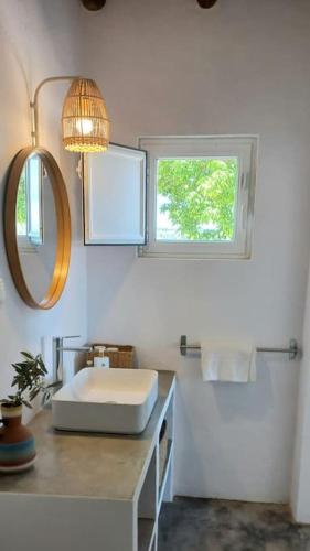 a white bathroom with a sink and a window at Fonte Freixo, em Borba, Alentejo in Borba