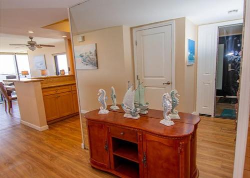 Una sala de estar con un armario de madera y una cocina. en Capri Beach Accommodations at Capri By The Sea, en San Diego