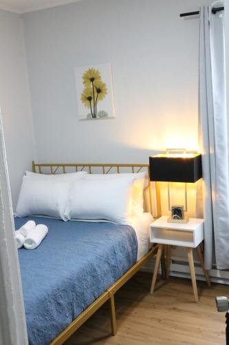 a bedroom with a bed and a night stand with a lamp at 4 bedroom short term rental furnished Apt in Schenectady