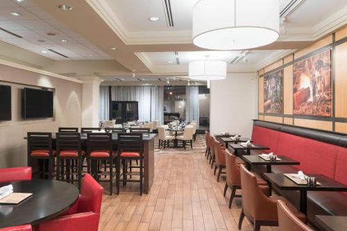a restaurant with black tables and red chairs at Pittsburgh Marriott City Center in Pittsburgh