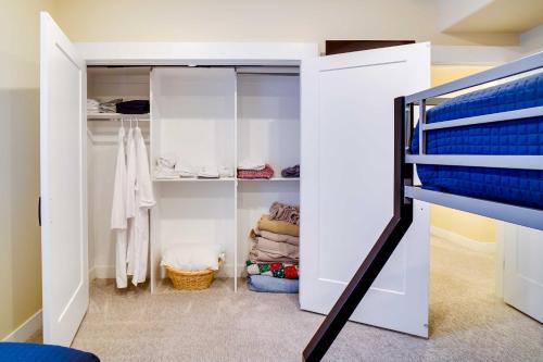 a bedroom with a bunk bed and a closet at Contemporary Home with Grill Near Utah Lake! in Saratoga Springs