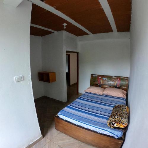 a bedroom with a bed with a cheetah pillow at Hospedaje Naturaleza Viva in San Rafael