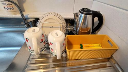 a kitchen sink with two dishes and a tray at Stay 230 in Danyang