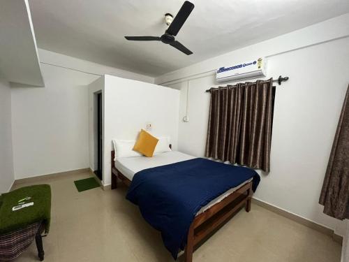 a bedroom with a bed and a ceiling fan at HAKUNA MATATA - Best budget stay at Arambol Beach, Goa in Arambol