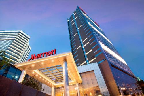 a large building with a marriott sign in front of it at Shanghai Marriott Hotel Riverside in Shanghai