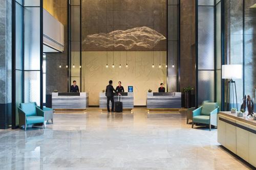 a lobby with people sitting at reception desks at Chongqing Marriott Hotel in Chongqing