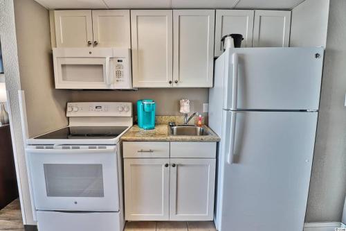 a kitchen with white appliances and a white refrigerator at Caravelle Resort in Myrtle Beach