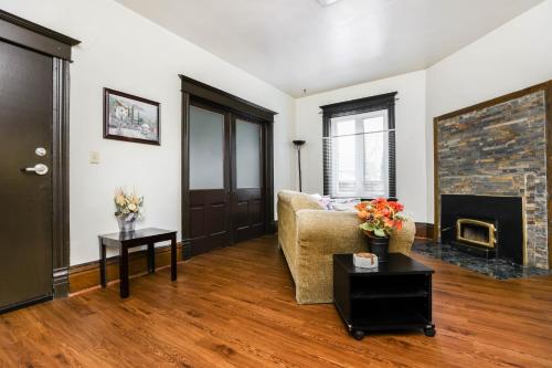 a living room with a couch and a fireplace at Wolseley the heart of the city ! in Winnipeg