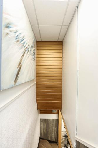 a hallway in a building with a painting on the wall at Wolseley the heart of the city ! in Winnipeg
