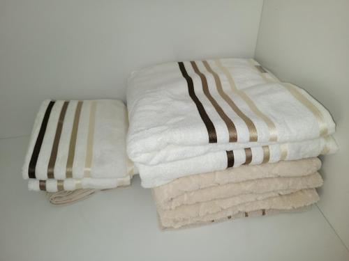 two stacks of towels sitting on a shelf at Vista para o Guaíba in Porto Alegre
